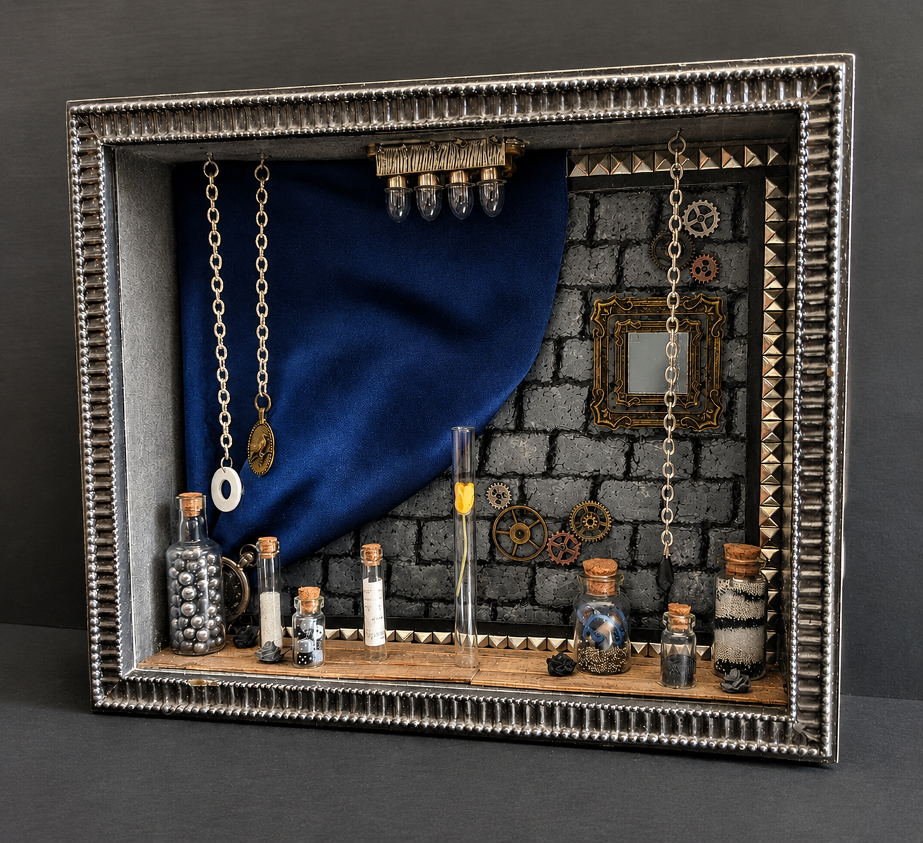 Miniature gothic room assembled inside an ornate silver frame