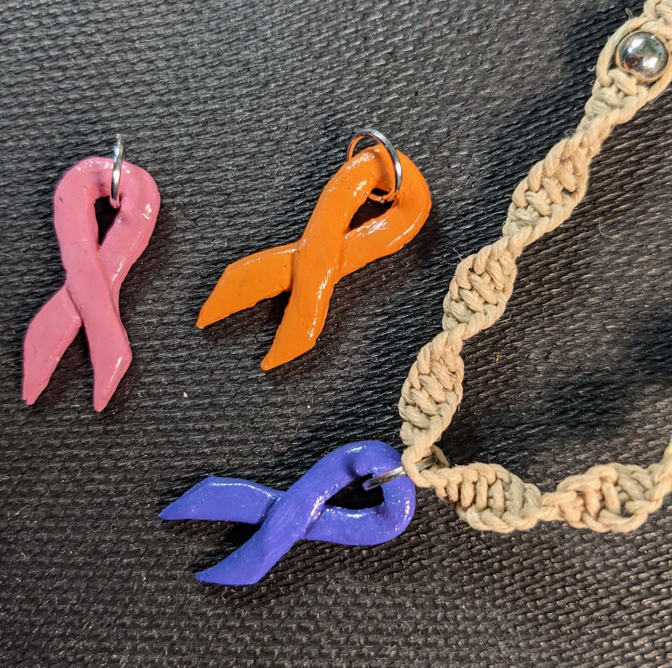 Pink, orange, and violet awareness ribbon pendants