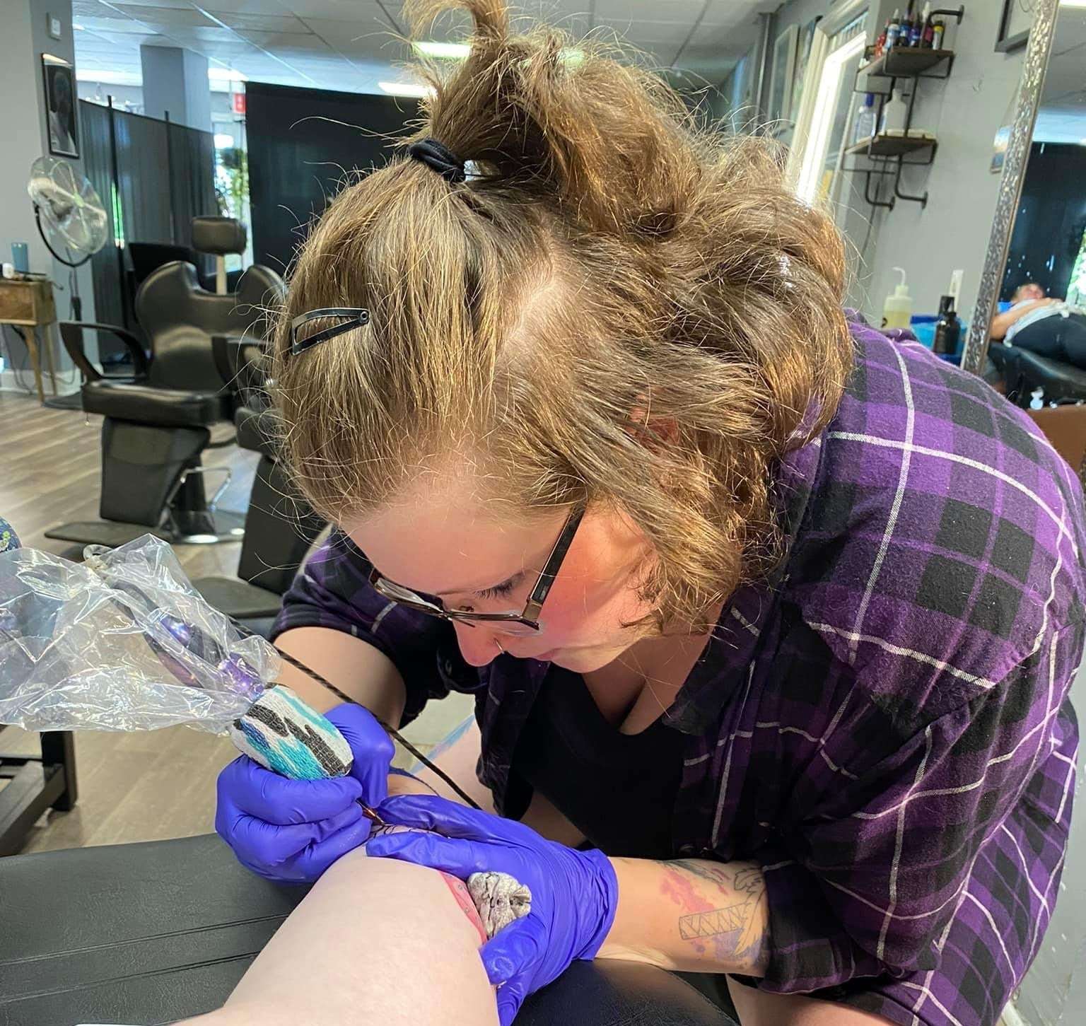 Casey Marie Roy concentrating while creating a tattoo