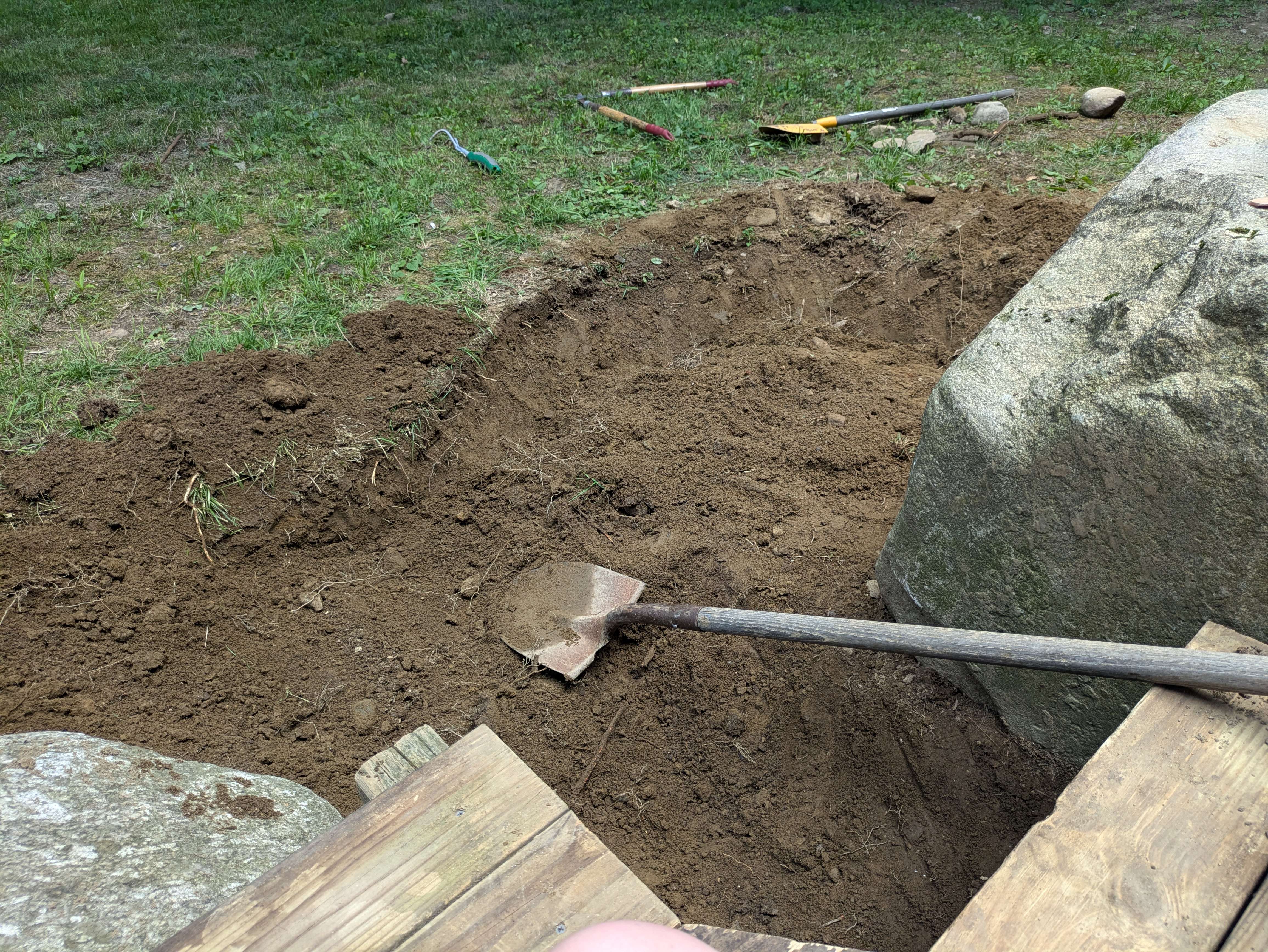 Ground excavated around a large stone