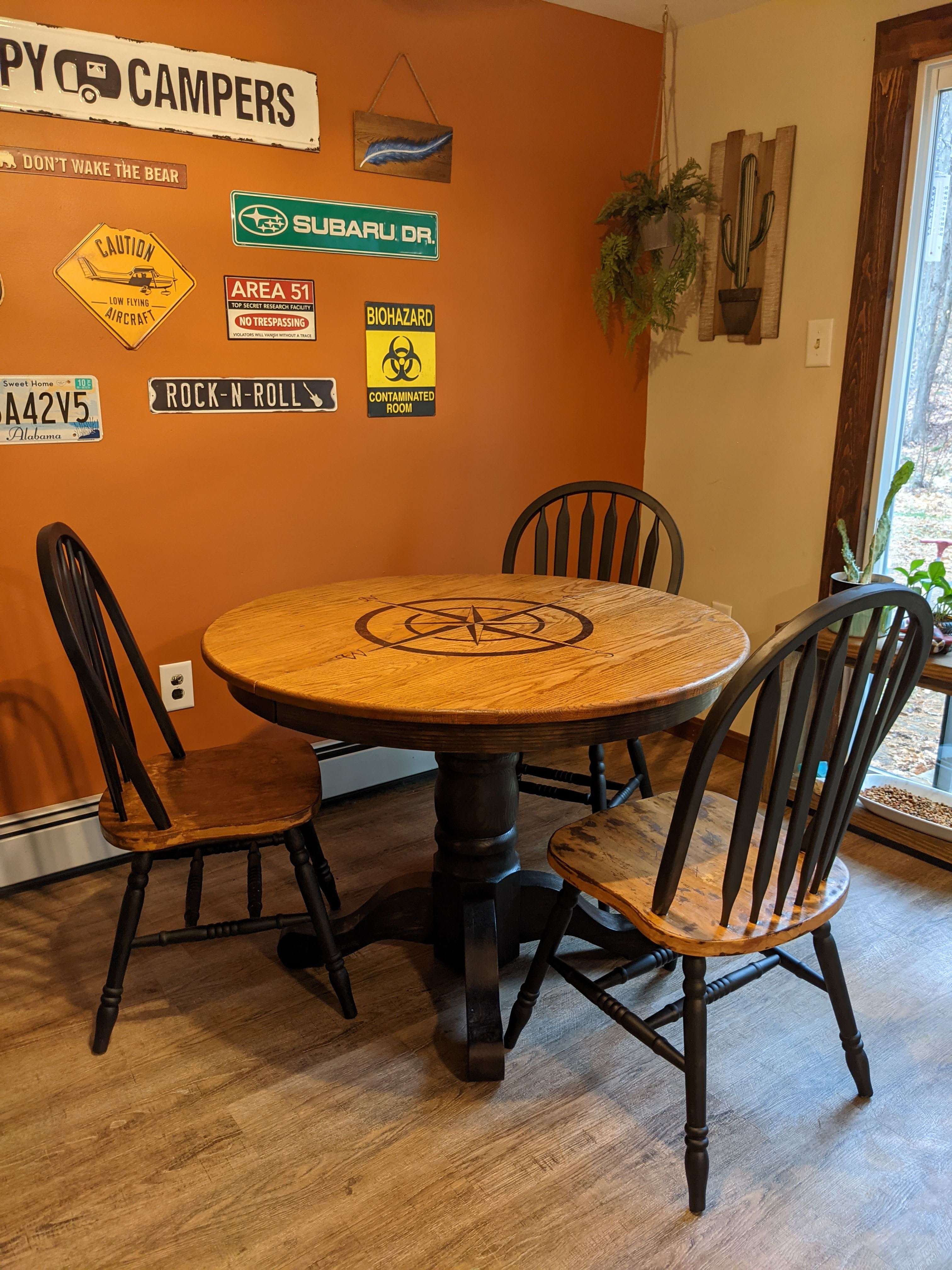 Round compass table in a warm orange dining nook