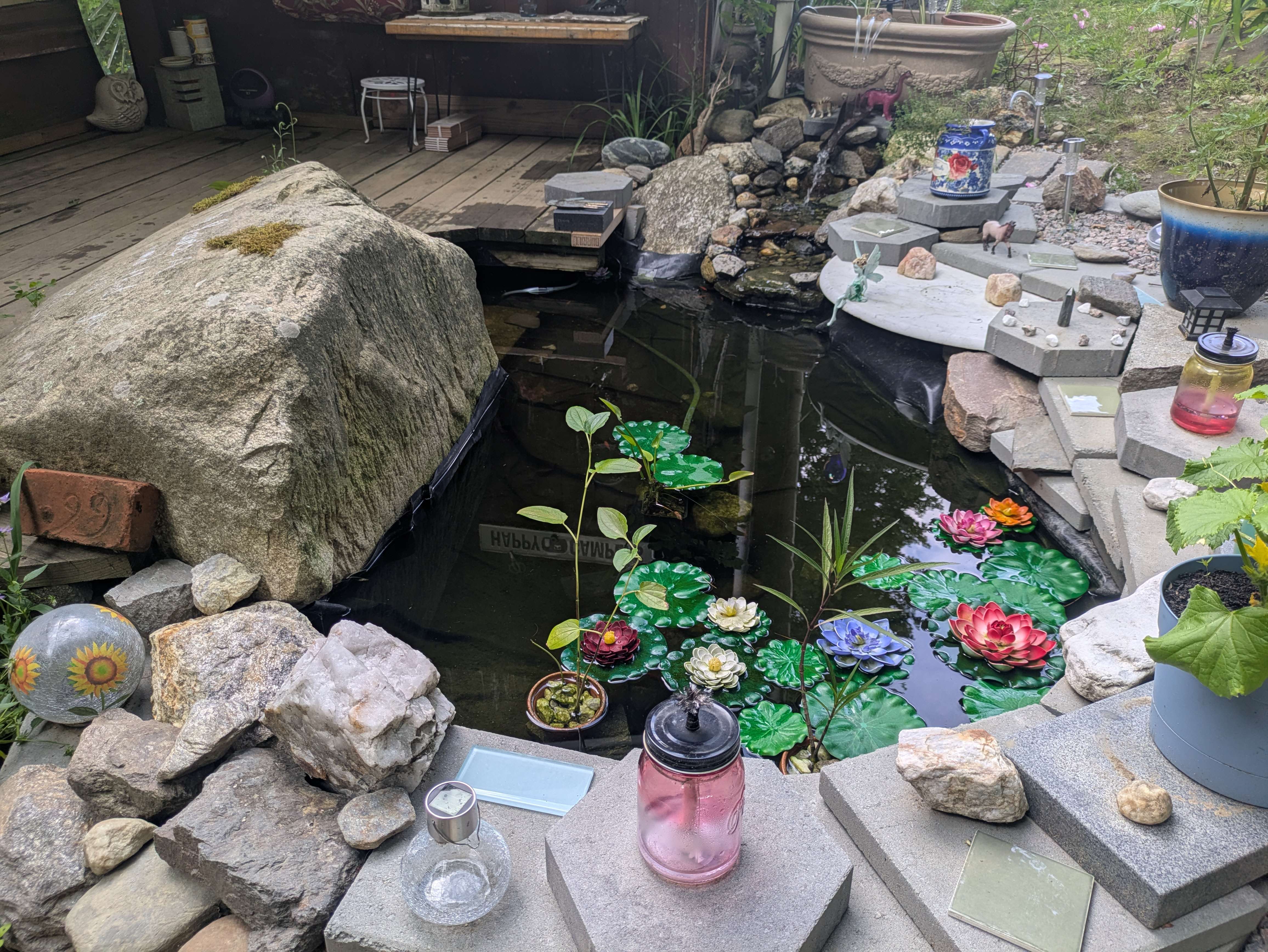 Reflective water and mature plantings in the completed garden