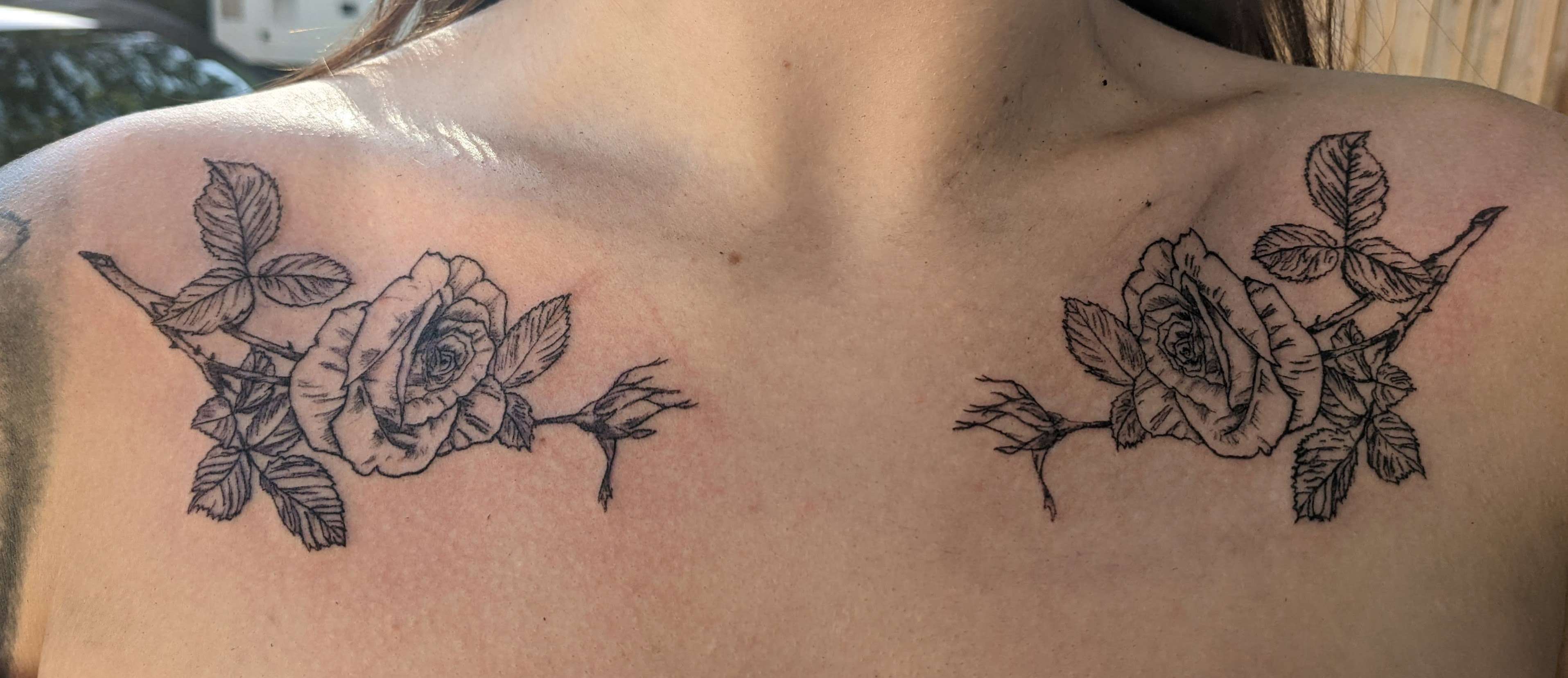 Paired rose tattoos across a client's clavicles